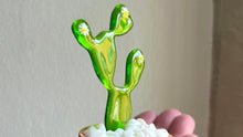 Load image into Gallery viewer, Glass cactus in a small terracotta pot held in artists hand against a neutral background